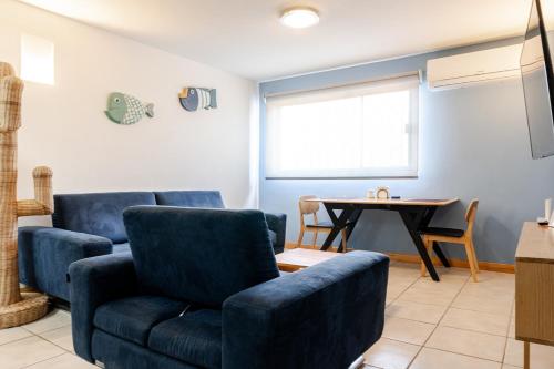 a living room with a blue couch and a table at Marina AZUL To live La Paz in La Paz