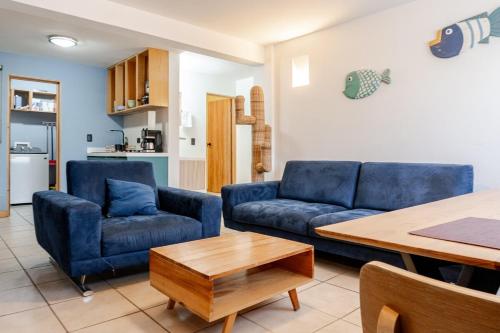a living room with two blue couches and a table at Marina AZUL To live La Paz in La Paz