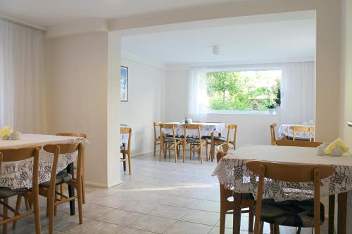a dining room with tables and chairs and a window at Anka in Władysławowo