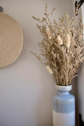 a blue vase with some dried flowers in it at Little Heaven shepherds hut in Glengarriff