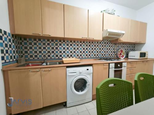a kitchen with a washing machine and a washer at Marina Yasmine Hammamet Luxury residence in Yasmine