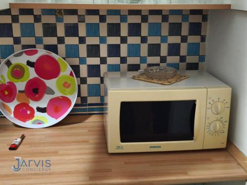 a microwave sitting on a counter with a plate at Marina Yasmine Hammamet Luxury residence in Yasmine
