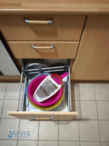 a drawer in a kitchen with a plate and dishes at Marina Yasmine Hammamet Luxury residence in Yasmine