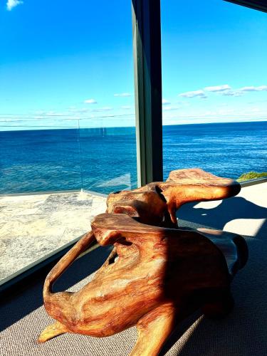 a piece of wood sitting in front of a window at Ocean view home South Coogee in Sydney