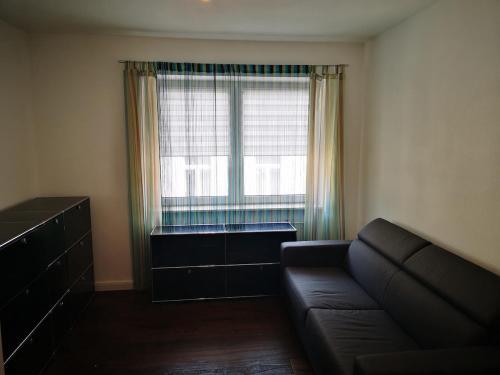 a living room with a couch and a large window at Centrally located spacious flat close to Rhine in Bonn