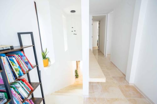 a hallway with a book shelf filled with books at Villa Les Chants Vallonnés in Spéracèdes