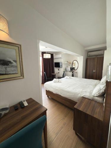 a hotel room with a bed and a table and a room at Slimiza Suites in Sliema