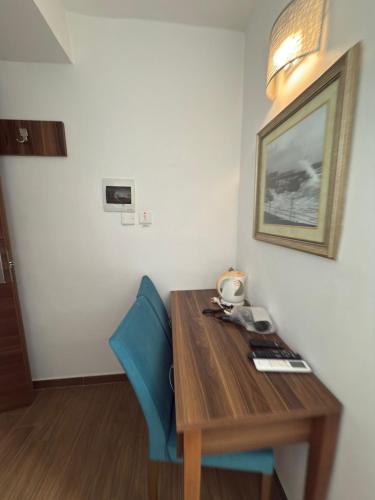 a room with a wooden table and blue chairs at Slimiza Suites in Sliema