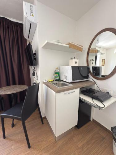 a small kitchen with a sink and a mirror at Slimiza Suites in Sliema
