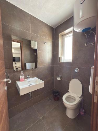 a bathroom with a toilet and a sink at Slimiza Suites in Sliema