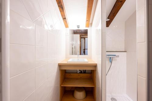 a bathroom with a sink and a mirror at Studio 18 - Le Chamois in Crest-Voland