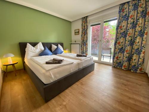 a bedroom with a large bed and a large window at Villa Mira in Klopein am Klopeiner See