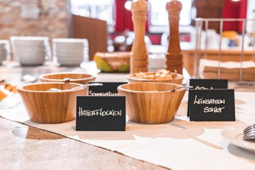 a table with wooden bowls on top of a table at Pirker's Natur- & Bio Familienhotel in Malta
