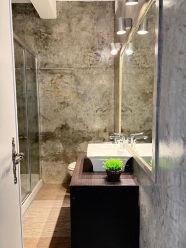 a bathroom with a sink and a glass shower at Cosy apartment Estoril in Estoril