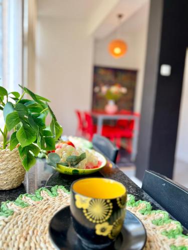 a table with a cup and a plate of food at Cosy apartment Estoril in Estoril