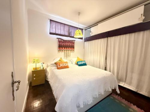 a bedroom with a white bed and a window at Cosy apartment Estoril in Estoril