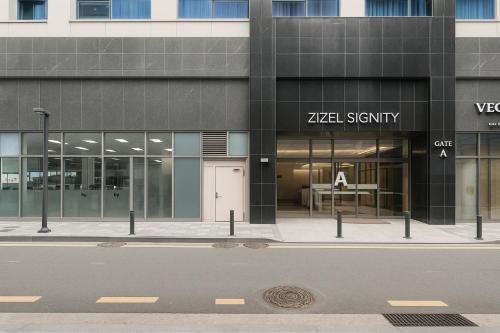 a view of a building with a sign on it at Zizel Suite Room Seocho in Seoul