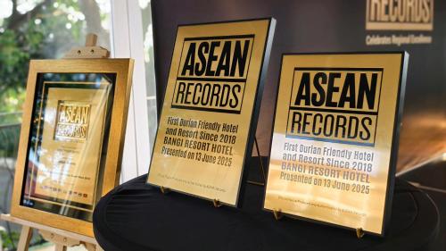 a table with two framed posters on a wall at Bangi Resort Hotel in Bangi
