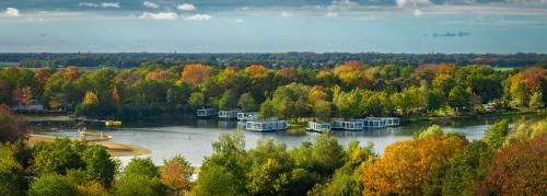 a view of a river with boats on it at Glamping BreeBronne in Maasbree