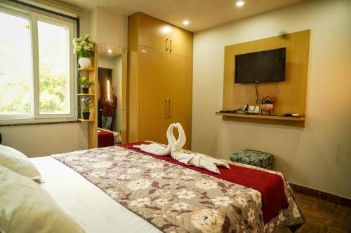 a bedroom with a bed with a bow on it at Rose Manor suites in Dehradun