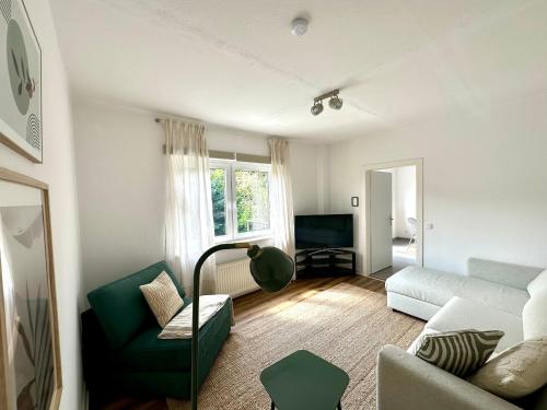 a living room with a couch and a chair at Gemütliche Ferienwohnung in Emmerich