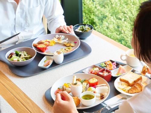 a table with plates of food on top of it at Kobe Suma Seaworld Hotel in Kobe