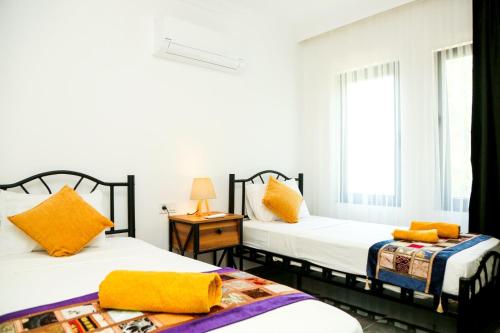 two beds sitting next to each other in a room at Villa Kaan in Ortaca