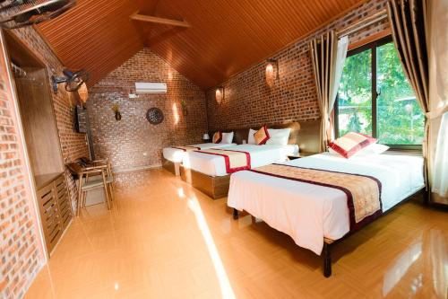 Кровать или кровати в номере Tam Coc Mr Loa Bungalow & Resort