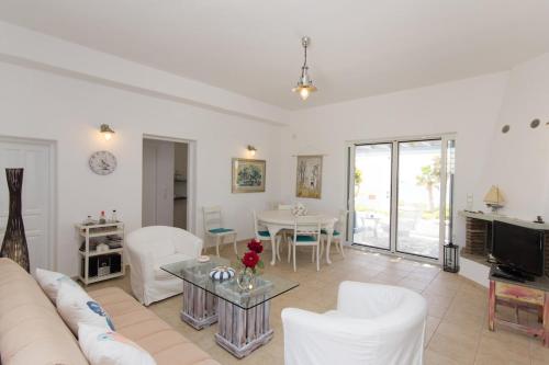 a living room with a couch and a table at Villa Maria, Golden Beach, Paros in Kampos Paros