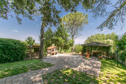 a garden with a brick walkway and a gazebo at Villa Bagolini in Mentana