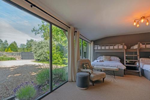 a bedroom with a bed and a large window at Lavender Lodge in Bath