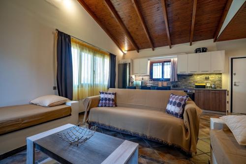 a living room with a couch and a table at Seaside Serenity Retreat - Nea Makri by ΜΡS in Nea Makri
