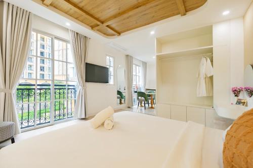 ein Schlafzimmer mit einem großen Bett und einem großen Fenster in der Unterkunft Hub Multi Hotel Phu Quoc in Phu Quoc