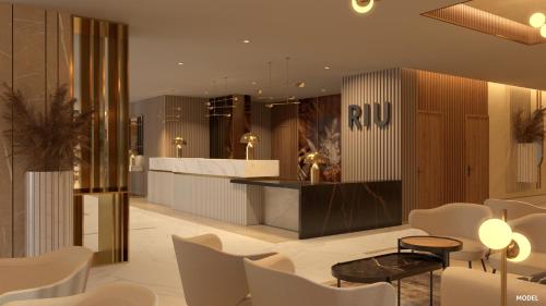 a lobby with white chairs and a ruc counter at Hotel Riu Palace Calypso - Adults Only in Playa Jandia