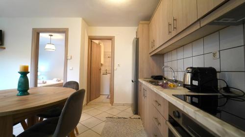 a kitchen with a table and a counter top at Casa Maria in Agiá