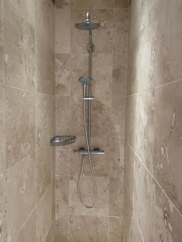 a shower with a shower head in a bathroom at Luxurious Granny House Bell Busk in Malhamdale in Skipton