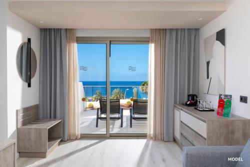 a living room with a view of the ocean at Hotel Riu Palace Calypso - Adults Only in Playa Jandia