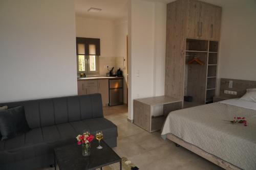 a living room with a couch and a bed and a kitchen at House of Harmony Standaard studio Mira ADULTS ONLY in Achlada