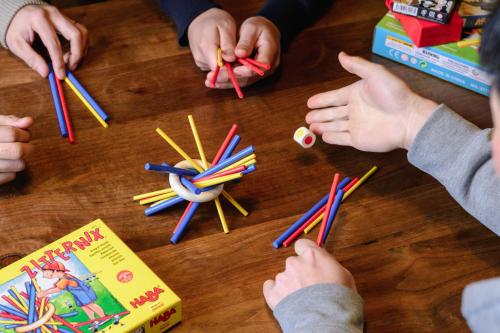 a group of children playing with colored pencils on a table at 山座熊川 Sanza-Kumagawa in Wakasa