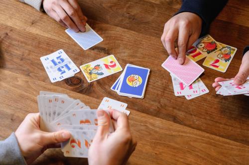 a group of people playing poker on a table at 山座熊川 Sanza-Kumagawa in Wakasa