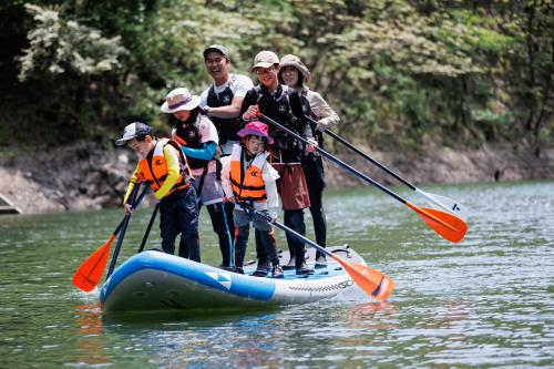 a group of people on a raft in the water at 山座熊川 Sanza-Kumagawa in Wakasa