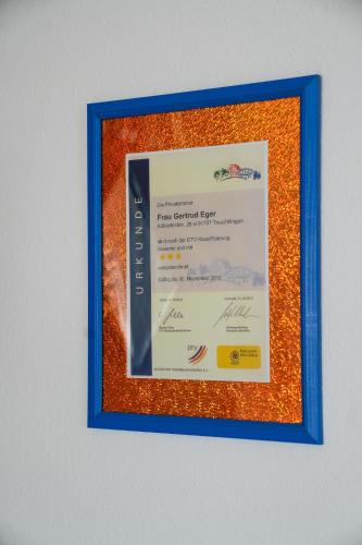 a framed picture of a certificate on a wall at Pension Eger in Treuchtlingen