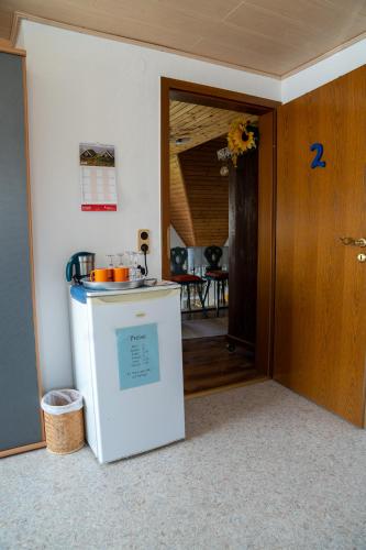 a kitchen with a small refrigerator in a room at Pension Eger in Treuchtlingen