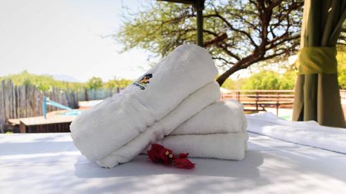 a stack of towels on a table in the snow at Samburu Elephant Lodge in Isiolo