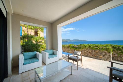 a patio with a view of the ocean at Lustica Bay Marina Village by 2BHome in Lustica
