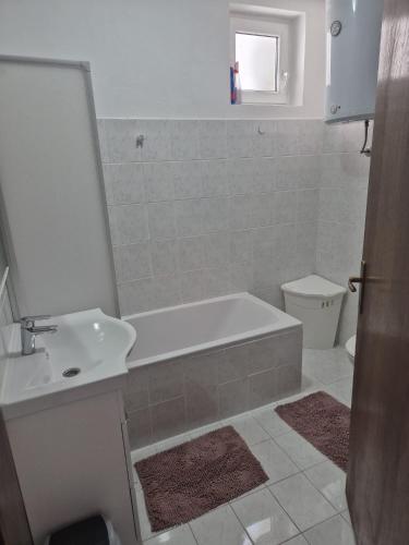 a bathroom with a tub and a sink and a toilet at Apartman Lopar 2,Crikvenica in Crikvenica