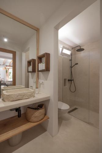 a bathroom with a shower and a sink and a toilet at Can Aisha in Es Pujols