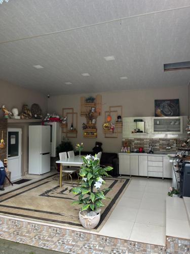 a living room with a table and a kitchen at Mehriban Guest House in Sheki