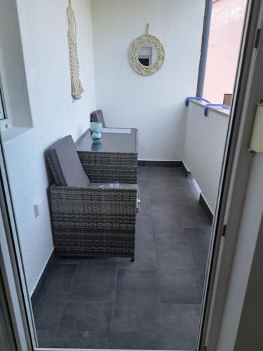a hallway with a chair and a table in a room at Apartman Lopar 2,Crikvenica in Crikvenica