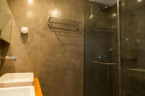 a bathroom with a shower and a sink at Grace Mykonos in Agios Stefanos